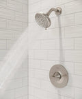 Weller Tub And Shower Valve Trim Kit With Single Handle Brushed Nickel Finish For OX8 Series, mounted on white tiled wall
