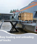 Heavy Duty Battery Powered Hydraulic Lift Table With Slide Rails For Trucks And Garages Offers 1100 Lb Capacity Zero Assembly Needed For Solo Workers To Load Cargo Safely And Effortlessly With Instant Electric Power And Comfort, positioned on a truck bed with a wooden crate.