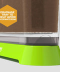 Close-up of drainage tray in Edible Veggie Garden Watch It Grow Kit For Kids showing soil inside clear green base container.