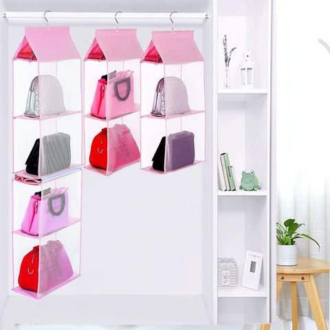 Space Saving Hanging Purse Organizer With Four Compartments For Closet Storage, showing handbags neatly stored in pink fabric.