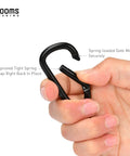 Hand holding a black carabiner clip showing spring gate from the 2.3 Inch Aluminum Carabiner Clip Keychain Set Grab And Go Ready D Ring Attachments