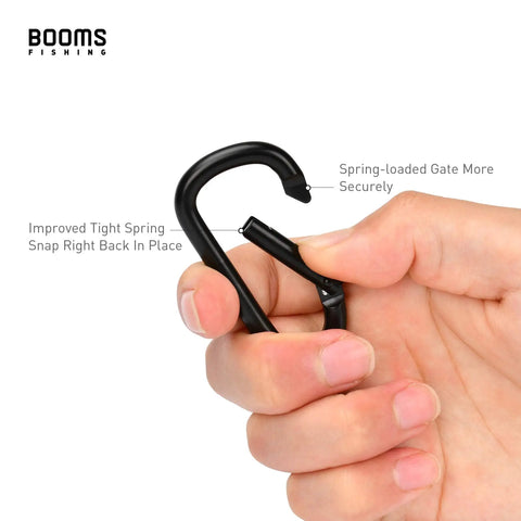 Hand holding a black carabiner clip showing spring gate from the 2.3 Inch Aluminum Carabiner Clip Keychain Set Grab And Go Ready D Ring Attachments
