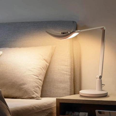 Eye Care Desk Lamp With Auto Dim, CRI 97, and adjustable color temperature in a bedroom setting, 51 inch wide illumination