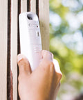 Hand holding the remote outdoor sensor of the Hunt Smarter With This Sportsman Weather Station For Hunting And Fishing Activity Meter.