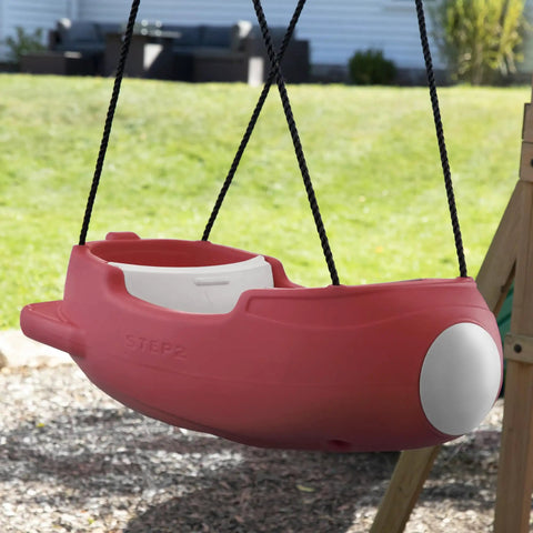 Red rocket swing with weather resistant rope, outdoor baby swing for toddlers 9 months to 3 years, attached to playset in the backyard.