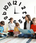 Teacher reading with children in front of Multiplication Chart Posters For Classroom Black And White Bulletin Board Paper Cutouts 1 To 12 Numbers Skip Counting For Back To School And Home Learning Includes Glue Points And Large Cutouts clock decor.