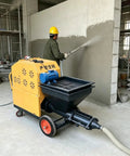 Heavy Duty Multifunctional Construction Spraying Machine For Cement Sand Mortar Wall Plaster in action applying plaster to a wall.