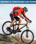 Cyclist on mountain bike using 8 Pairs Resin Semi Metallic Bike Brake Pads For Mountain Disc Brakes, demonstrating control.