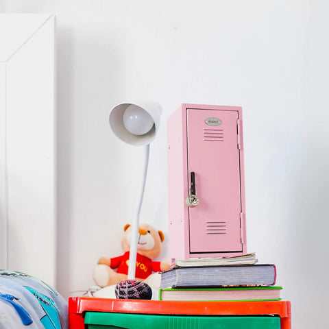 Pink Miniature Metal Locker With Secure Diary Lock And Two Keys For Hella Cute Desk Setup Soft Padded Base on a desk with books and a lamp.