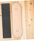 Non Slip Grip Tape For Skateboard Decks And Electric Scooters Heavy Duty PVC Material next to a skateboard deck on wood floor.