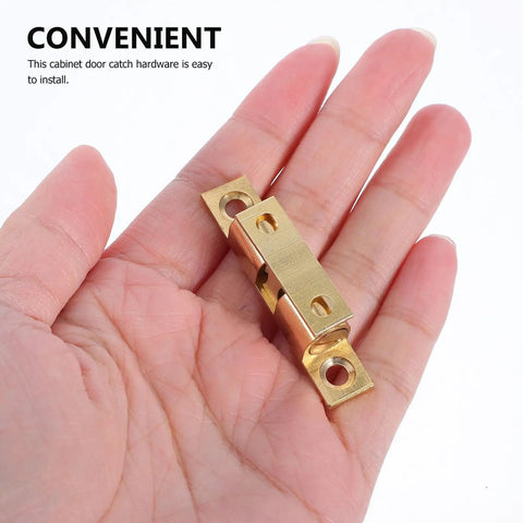Double Ball Tension Roller Catch Latch Set 4 Brass Cabinet Door Closures in hand, solid brass easy to install hardware