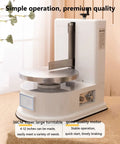 Smooth Operator Automatic Cake Cream Smoothing Machine With Button Press Controls And Custom Thickness Adjustments For Show Stopping Frosting Finishes Lightweight Pink Tool on a table with a stainless steel turntable.