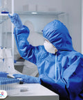 Person in blue disposable coveralls with hood in large size tri laminated SMS polypropylene work suit in laboratory setting