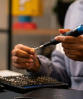 Person using Manta Driver Kit All In One Household PC Phone And Electronics Bit Set with premium knurled aluminum handle
