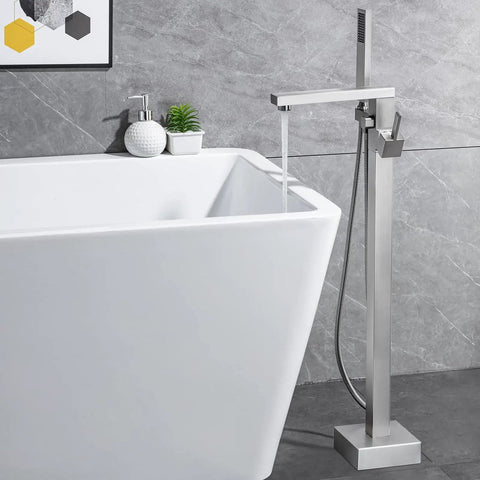 Freestanding Bathtub Faucet Floor Mounted Brass One Handle With Hand Shower Brushed Nickel Finish next to tub in modern decor