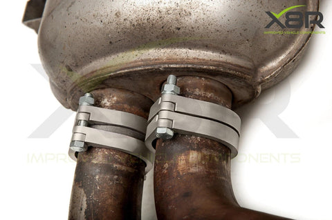 Close-up of a Repair Replacements Fix Kit For Rusted And Corroded Exhaust Flanges And Muffler Back Box Brackets installed on pipes.