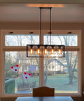 Black Farmhouse Style 5-Light Rectangle Chandelier With Glass Shades over a dining table, modern rustic vibe, 30x10 inch