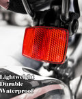 Close-up of red rear Six Pack Bike Reflectors Front And Rear With Wheel Spoke Brackets for Handlebar and Seat Post mounted on bike.