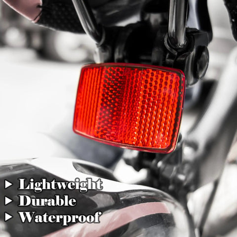 Close-up of red rear Six Pack Bike Reflectors Front And Rear With Wheel Spoke Brackets for Handlebar and Seat Post mounted on bike.