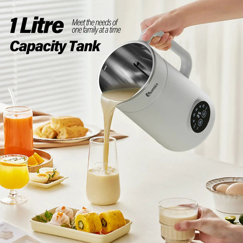 All In One Nut Milk Maker With 35 Oz Capacity, 10 Blades, One Touch Start, pouring milk into glass on countertop