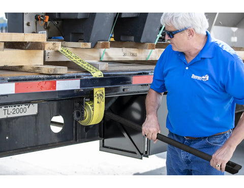Person using 40 Inch Combo Winch Bar For Steel Trailer Winches, Black Powder Coated Carbon Steel, Heavy-Duty Leverage Tool For Tightening Straps And Forged Load Binders On Tough Jobs on trailer.