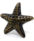 Starfish-shaped knob from Ocean Theme Cast Iron Door Knobs And Drawer Pulls Set Of 6 For Cabinets Dressers Wardrobes And Kitchen Cupboards Handmade Classic Hardware With Retro Bronze Finish Built To Last And Rust Resistant, shown in detail.