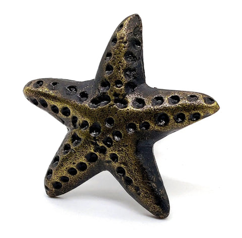 Starfish-shaped knob from Ocean Theme Cast Iron Door Knobs And Drawer Pulls Set Of 6 For Cabinets Dressers Wardrobes And Kitchen Cupboards Handmade Classic Hardware With Retro Bronze Finish Built To Last And Rust Resistant, shown in detail.