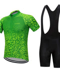 Green patterned cycling jersey and black bib shorts set displayed on white background.