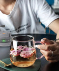 Glass cup with tea flowers next to a 2 Pack USB Charger Cable Dock for Hidrate Spark Pro Water Bottle Replacement Cord