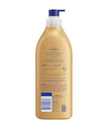 Back view of Game Changer Cocoa Butter Body Lotion 16.9oz tube showing the ingredients and benefits for dry skin.