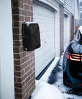 Hella Tough Weatherproof Electric Vehicle Charger Cover For Tesla Wall Connector Level 2 Charging Station, snowy outdoor setting.
