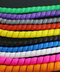 Assorted colored cable sleeves adjacent to the Spiral Cable Protector Sleeve 2M for 8 to 16mm Wires in Green Flame Retardant Spiral Tube