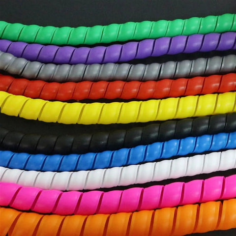 Assorted colored cable sleeves adjacent to the Spiral Cable Protector Sleeve 2M for 8 to 16mm Wires in Green Flame Retardant Spiral Tube