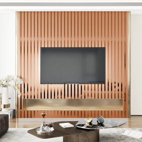 Ridiculously Sleek Rose Gold Metallic Peel And Stick Wall Panels Shimmer Stripe create a modern accent wall behind a TV.