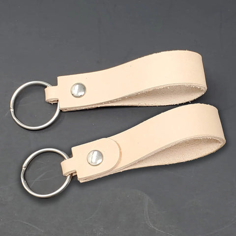 Premium Blank Natural Leather Keychains 10 Pack With Heavy Duty Metal Swivel Clasps showing leather strips with rings for customization.