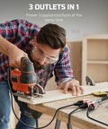 Man using saw with Heavy Duty 24 Inch 12 Gauge Indoor Tri Tap Extension Cord With LED Lighted Plug UL Listed 15A 125V 1875W