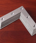 Heavy Duty Stainless Steel L Shaped Corner Brackets, 90 degree joint plate with predrilled holes on wooden surface.