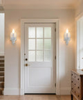 ZIRALIO Farmhouse Vintage Wall Sconce for Bedroom, 2-Pack installed beside a door, showcasing distressed white finish and soft lighting.