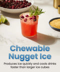 Chewable nugget ice in a red cocktail glass with rosemary and cranberries, sugar rim on a white countertop.