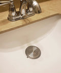 Bathroom Sink And Tub Hair Catcher 2 Pack Non Slip Drain Protector Anti Clog Filter in a white sink with chrome faucet.
