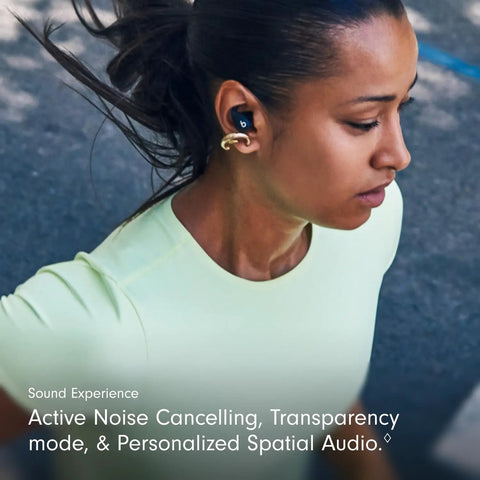 Woman running with Powerbeats Fit Wireless Earbuds With Secure Wing Tips For Gym Workouts, Bass Forward Noise Canceling Sound, in ear.