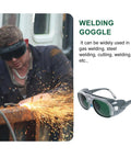 Badass Welding Glasses With Anti Glare Black And Gray Lenses Rock Solid Safety Goggles Built Tough For Industrial Dust And Splash Protection Sick Shop Eye Shield Two Pack worn by a man welding, sparks flying.