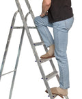 Person climbing a ladder wearing slippers, demonstrating safe access while inspecting smoke alarms with Heavy Duty Extendable Safety Pole With Killer Reach Ditch The Ladder Smoke Alarm Tester And Fire Sensor Checker Smooth Reach Emergency Exit Sign Tester For Top Notch Routine Care.