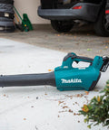 Renewed Brushless Cordless Leaf Blower with black nozzle on garage floor, great for yard work with 459 Cfm and 116 Mph blast.