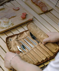 Trail Ready Stainless Steel Camping Utensil Kit with Spoon Fork Chopsticks, portable set on a wooden table with a canvas case