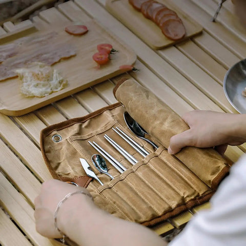 Trail Ready Stainless Steel Camping Utensil Kit with Spoon Fork Chopsticks, portable set on a wooden table with a canvas case