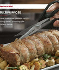 All Purpose Kitchen Shears with Protective Sheath cutting roasted meat, black handles, and stainless steel blades