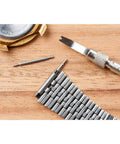 Heavy Duty 18mm Watch Spring Bar Pins Made From Rust Proof 316 Stainless Steel For Zero Hassle Strap Swaps And Lock Tight Lug Link Security Pack Of Two tools and watch parts on wooden surface.