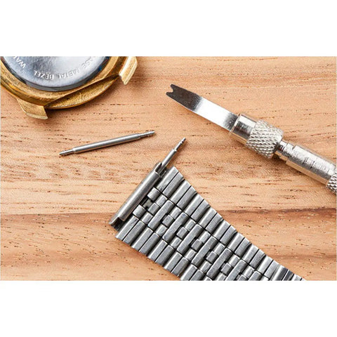 Heavy Duty 18mm Watch Spring Bar Pins Made From Rust Proof 316 Stainless Steel For Zero Hassle Strap Swaps And Lock Tight Lug Link Security Pack Of Two tools and watch parts on wooden surface.