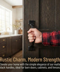 Hand holding matte black gate handle on wooden door, Matte Black Gate Handles Set Of 10 5.5 Inch Barn Door Pulls For Cabinets, Drawers, Fences, And Outdoor Use Screw On Hand Grips With Rustic Farmhouse Style For Kitchen Hardware.